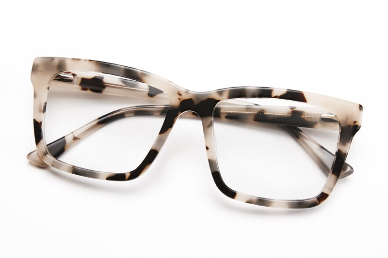 Tortoise-shell wayfarer eyeglasses with clear lenses and thick square frames.