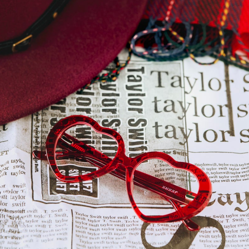 Red heart-shaped glasses with "Taylor Swift" text background.