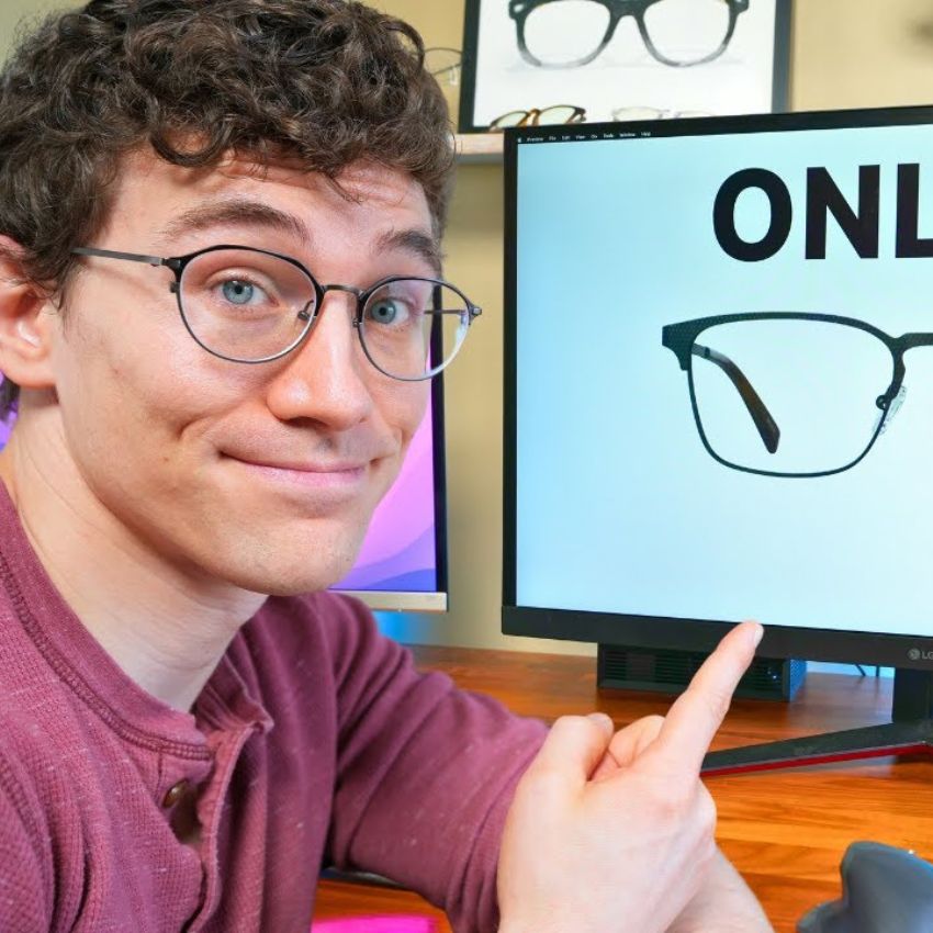 Man pointing at a monitor displaying the text "ONLY" next to an image of eyeglasses.